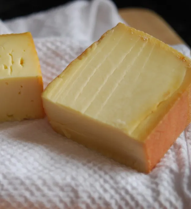 Artisan smoked dry cheese with a golden smoked rind