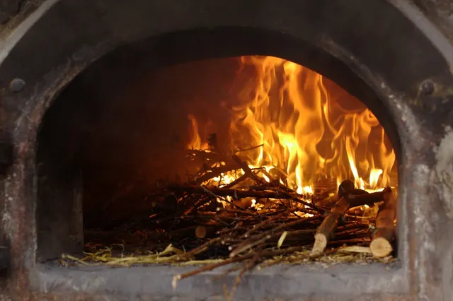 Wood fire burning inside a traditional smoking oven